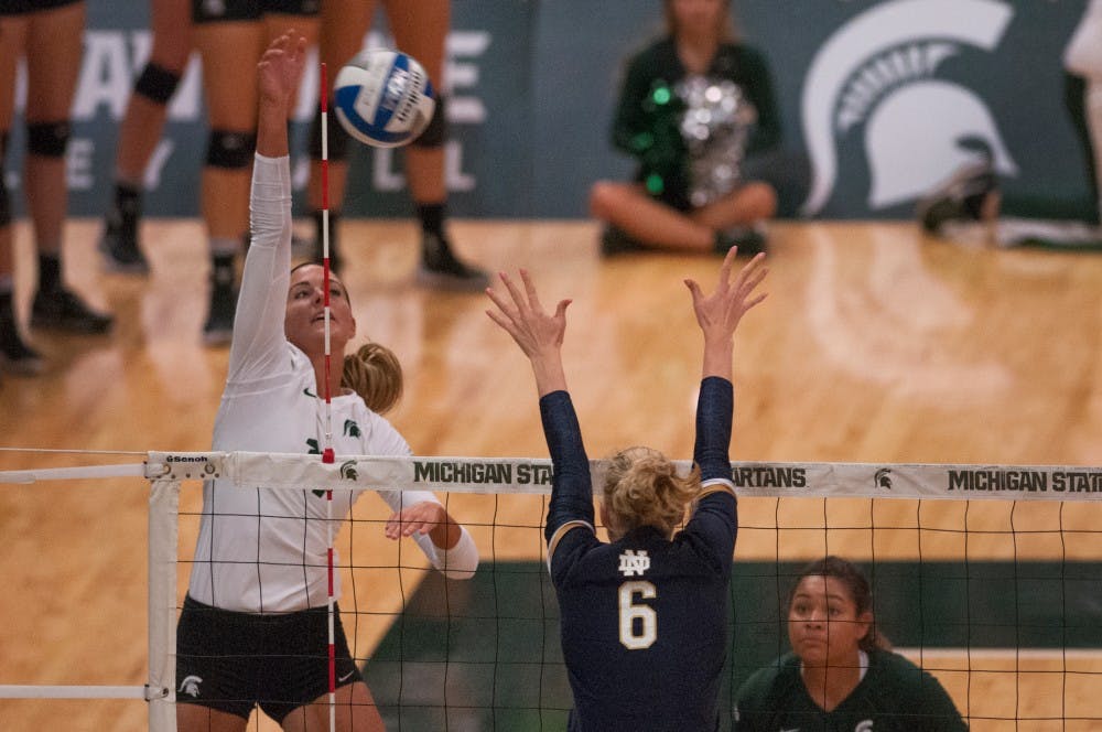 Senior outside hitter Chloe Reinig (11) spikes the volleyball during the volleyball game against Notre Dame on Sept. 16, 2016 at Jenison Field House. The Spartans defeated the Fighting Irish, 3-0.