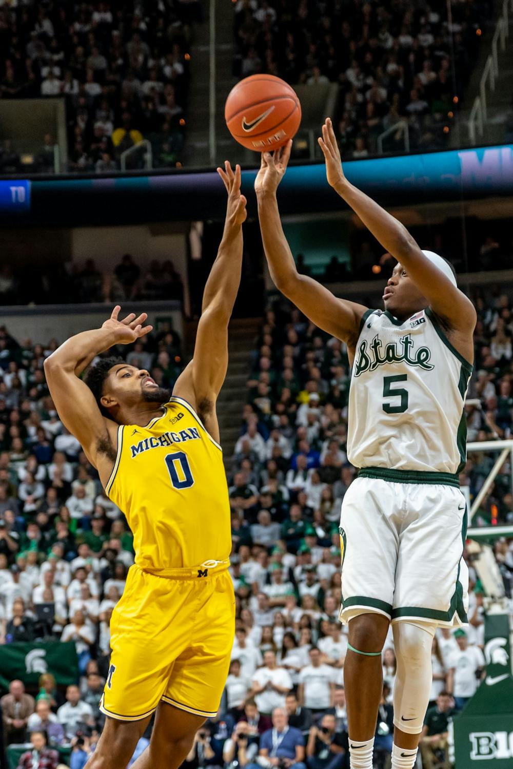 Senior guard Cassius Winston (5) shoots over Michigan guard David DeJulius (0).The Spartans defeated Michigan, 87-69, at the Breslin Student Events Center on January 5, 2020. 