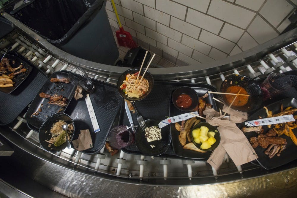 Leftover food waits to be thrown in the trash by dinning hall employees on Sept. 21, 2016 at Holden Hall. 