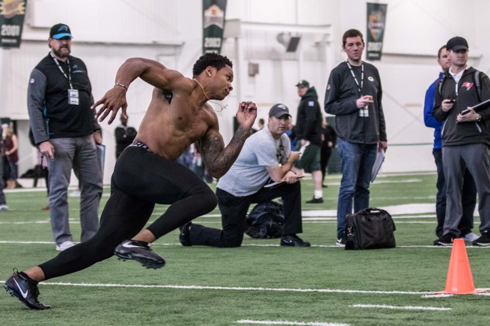 Running back Gerald Holmes runs a cone drill at MSU's pro day on March on March 23, 2018 at the Duffy Daugherty Football Building. MSU worked out five players at the pro day.