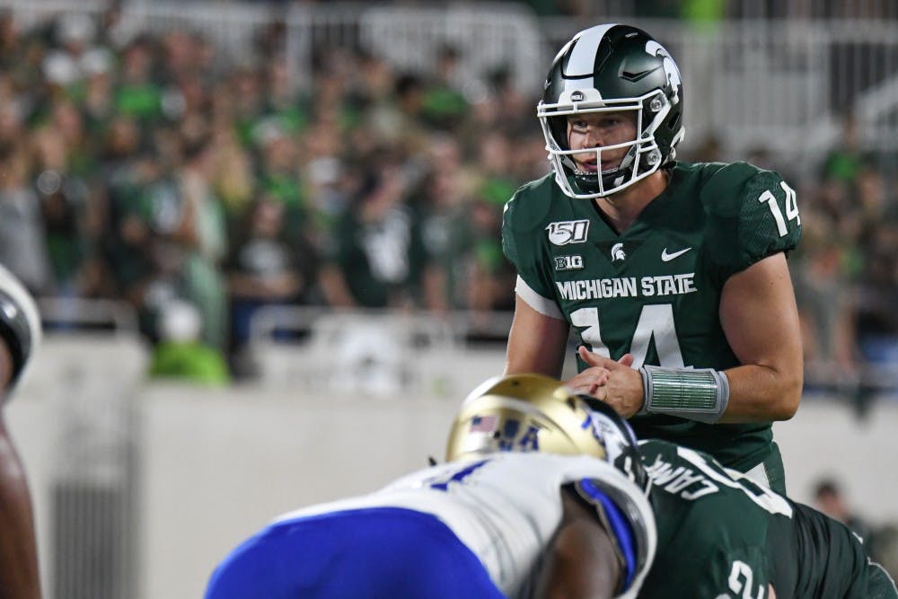 Redshirt senior quarterback Brian Lewerke (14) takes the snap during the game against Tulsa at Spartan Stadium Aug. 30, 2019. The Spartans defeated the Golden Hurricane, 28-7.