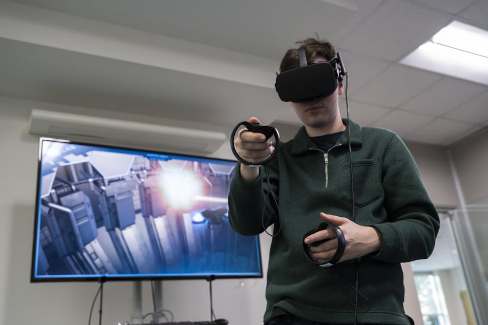 The MSU Library worker demonstrates one of the VR headsets for gaming at MSU Library's new VR room on Jan. 16, 2024. 