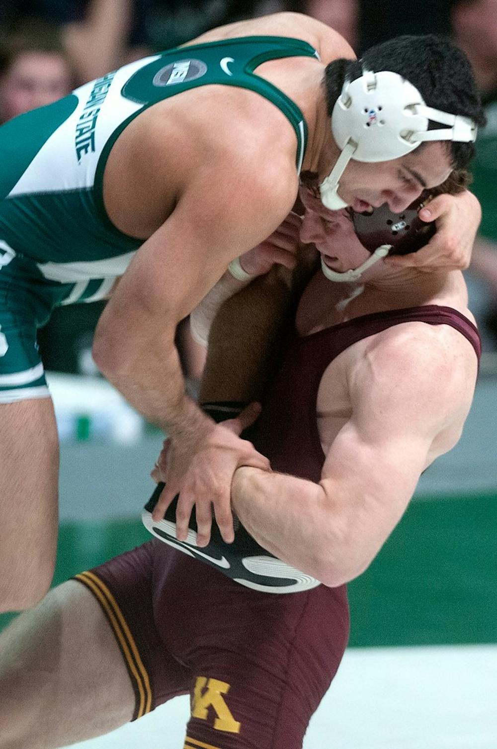 <p>Junior 184-pounder John Rizqallah wrestles Minnesota's Kevin Steinhaus on Jan. 17, 2014 at Jenison Field House. Steinhaus defeated Rizqallah, 16-1. Betsy Agosta/The State News</p>