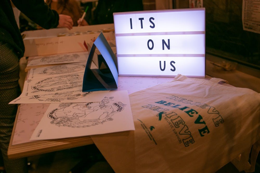 <p>A sign reads &quot;IT&#x27;S ON US&quot; at the Art of Surviving event at Blue Owl Coffee in East Lansing Oct. 14, 2019.</p>