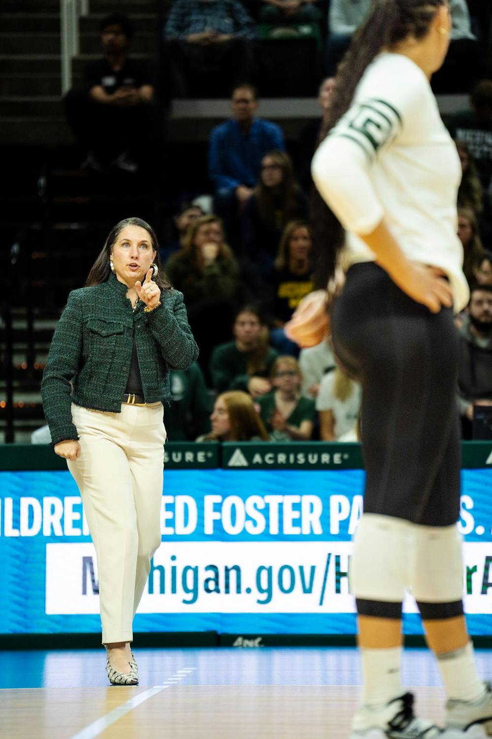 Michigan State head volleyball coach Leah Johnson addresses her players during the game against the University of Michigan at the Breslin Center on Nov. 15, 2024.