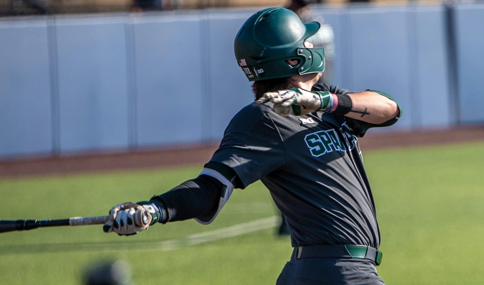 <p>Freshman infielder Brock Vradenburg (48) hits the ball resulting in a single. The Wolverines made a comeback in the ninth inning to top the Spartans, 8-7, at Ray Fisher Stadium on March 21, 2021.</p>