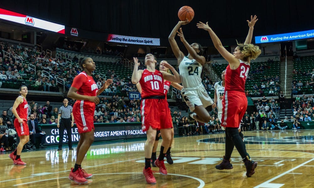 <p>Freshman guard Nia Clouden (24) drives to the basket on Ohio State's Carly Santoro. The Spartans lost to the Buckeyes, 70-77, on Feb. 21, 2019 at the Breslin Center.</p>