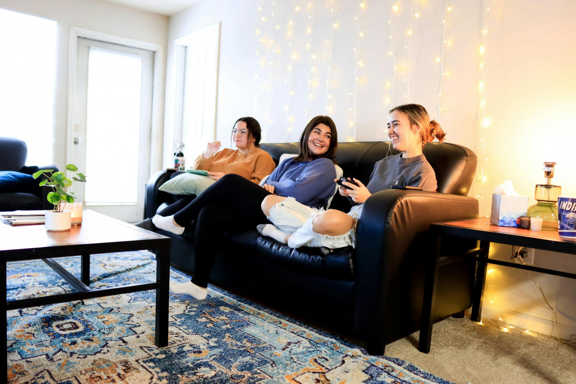 <p>Sophomore roommates Gabriella Lopez and Bella Johnson watch their roommate Jenna Drew play video games. Taken on Feb. 14, 2022.</p>