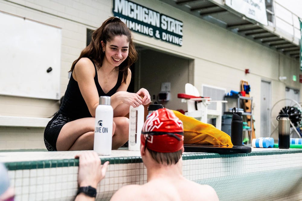 Michigan State Swim Club president and supply chain senior Deema El-Mouazzen talks with mechanical engineering sophomore Ryan Anderson during practice at the IM West Fitness Center on Michigan State University’s campus in East Lansing, Mich., on Tuesday, May 7, 2026.