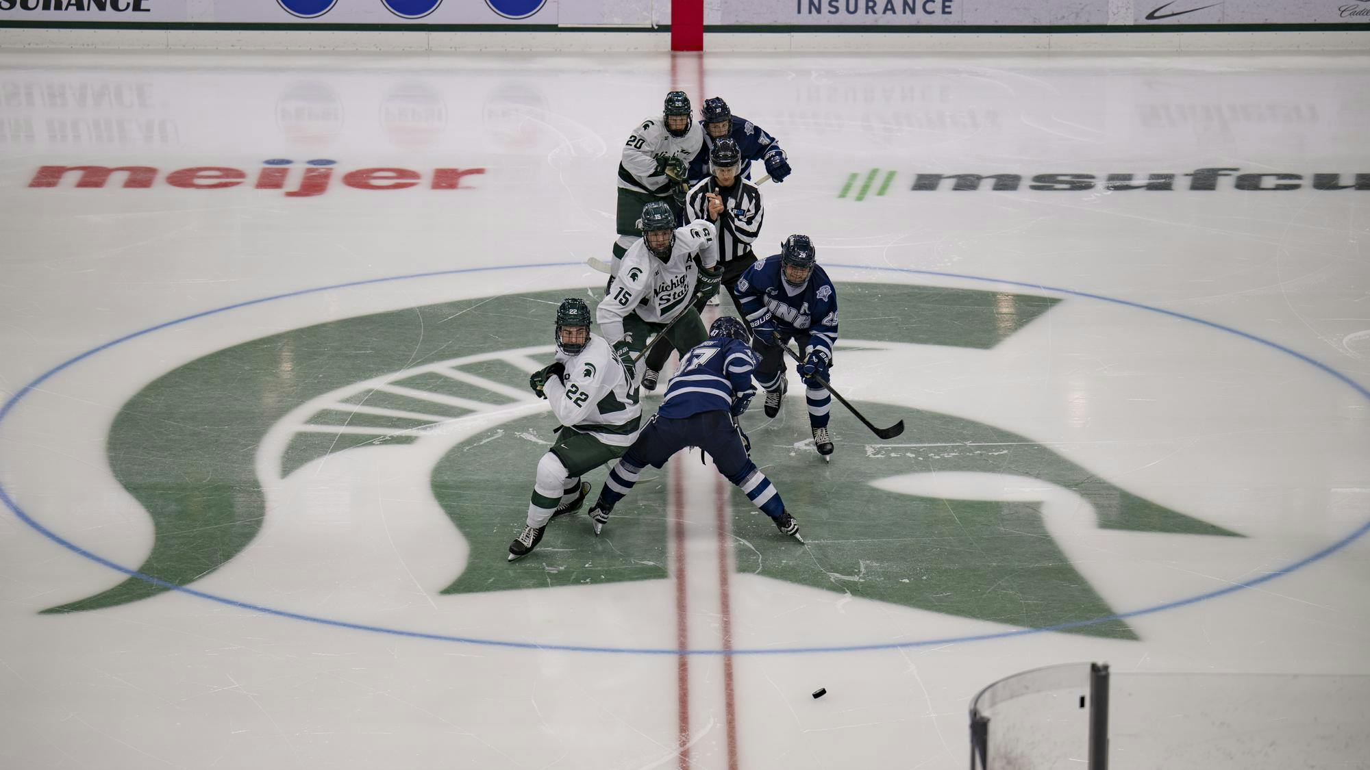 <p>Players from both teams line up at center ice for a faceoff following Michigan State’s goal at Munn Ice Arena on Oct. 10, 2025.</p>
