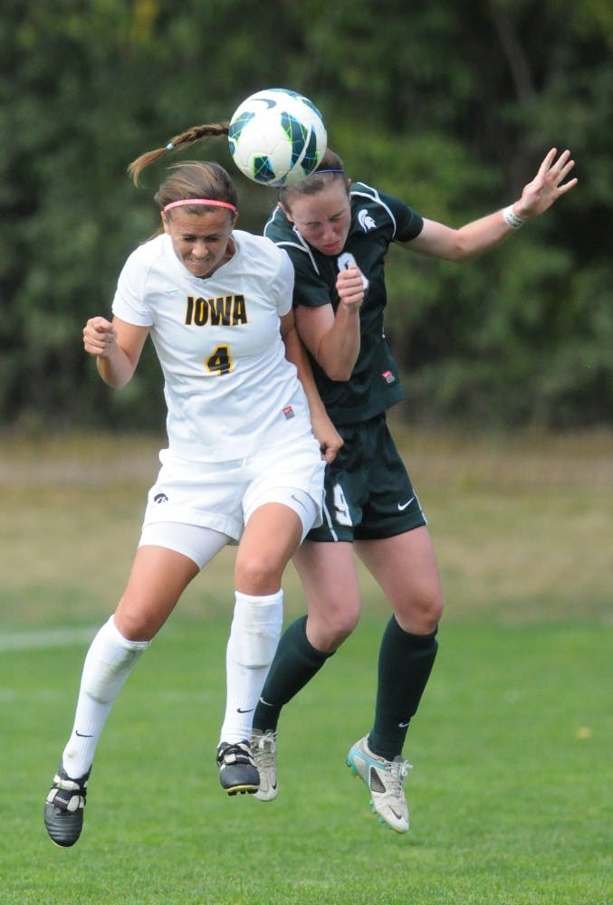 	<p>Senior midfielder Jordan Mueller goes for a header with Iowa Allie Adam. The Spartans tied with the Hawkeyes, 0-0, on Sunday, Sept. 30, 2012 at DeMartin Stadium. Justin Wan/The State News</p>