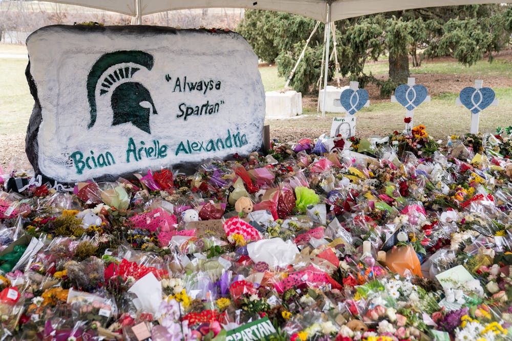 The Rock on Farm Lane surrounded by flowers and messages of support on Feb. 21, 2023. 