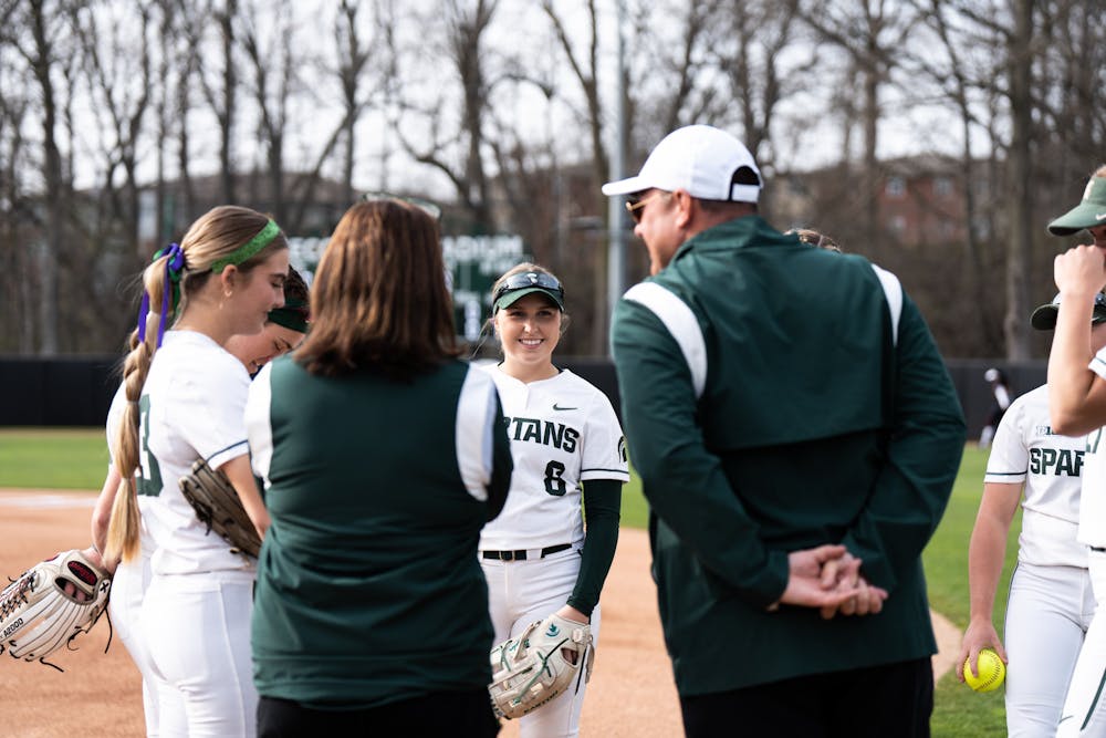<p>MSU player Brooke Snyder and her teammates catch up with their coaches before their game against Maryland on April 29th, 2022.</p>