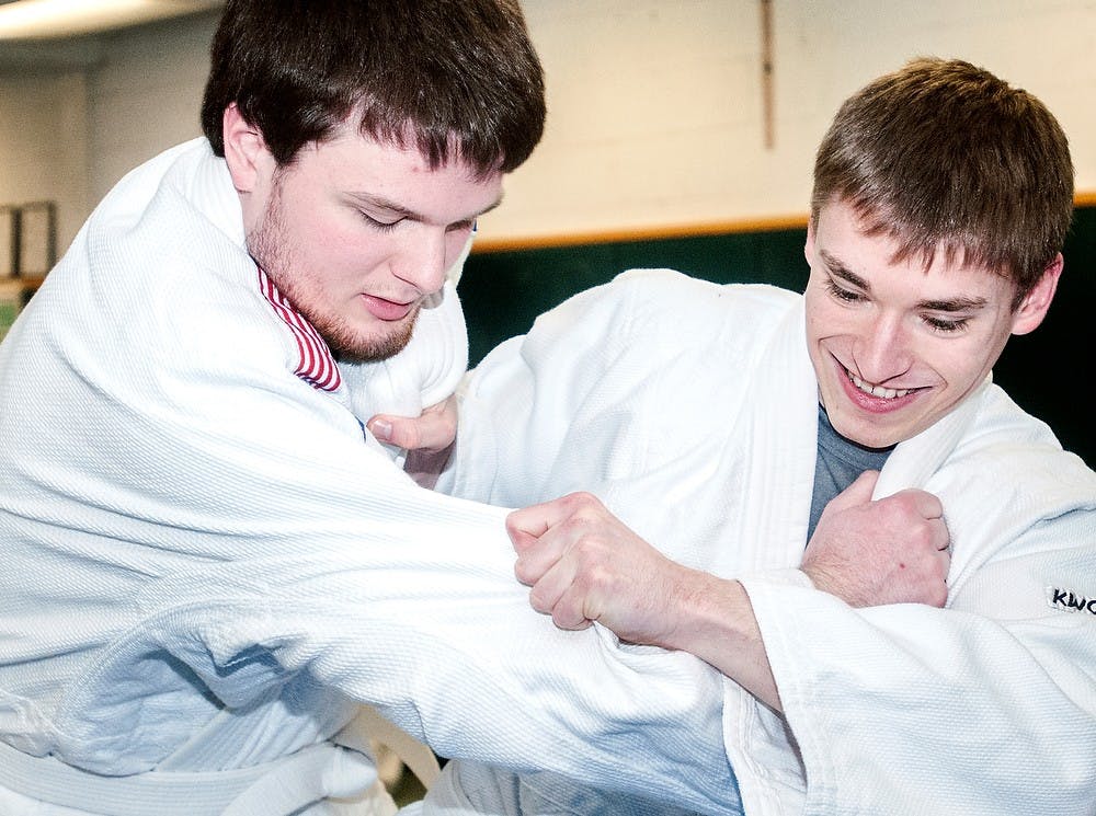 	<p>From left, mechanical engineering freshman Brett Vitous and marketing senior Brandon Nalezyty practice martial arts moves before taking a test in their Judo I class Wednesday, March 20, 2013, at IM Sports-West. Many students go into the class knowing it can be challenging at times. </p>