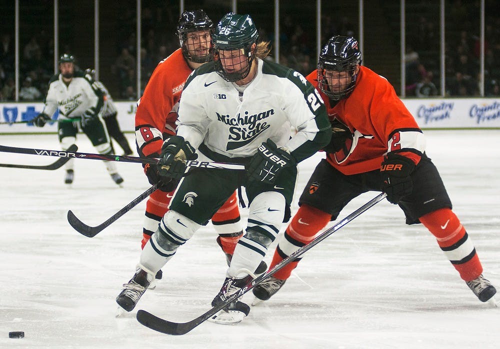 	<p>Freshman forward Villiam Haag skates the puck down the ice away from Princeton defensemen Jeremy Goodwin, 6, and Alec Rush, 2, on Dec. 1, 2013, at Munn Ice Arena. The Spartans defeated the Tigers, 8-2. Danyelle Morrow/The State News</p>