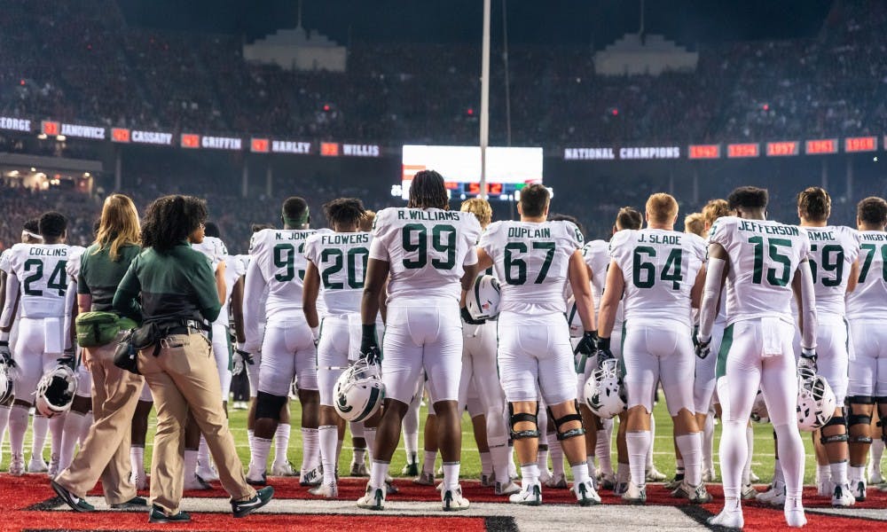 Spartan football players stand for the national anthem before playing Ohio State. The Buckeyes defeated the Spartans, 34-10, at Ohio Stadium on October 5, 2019. 