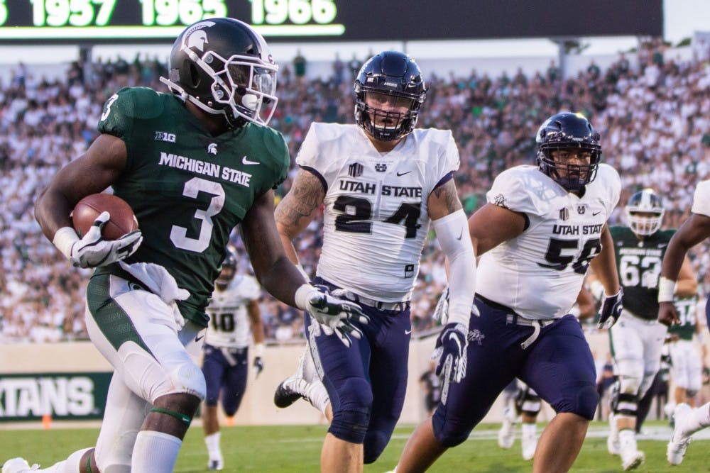 Senior running back LJ Scott (3) carries the ball up the sideline during the game against Utah State on Aug. 31 at Spartan Stadium. The Spartans led the Aggies, 20-14 at the half.