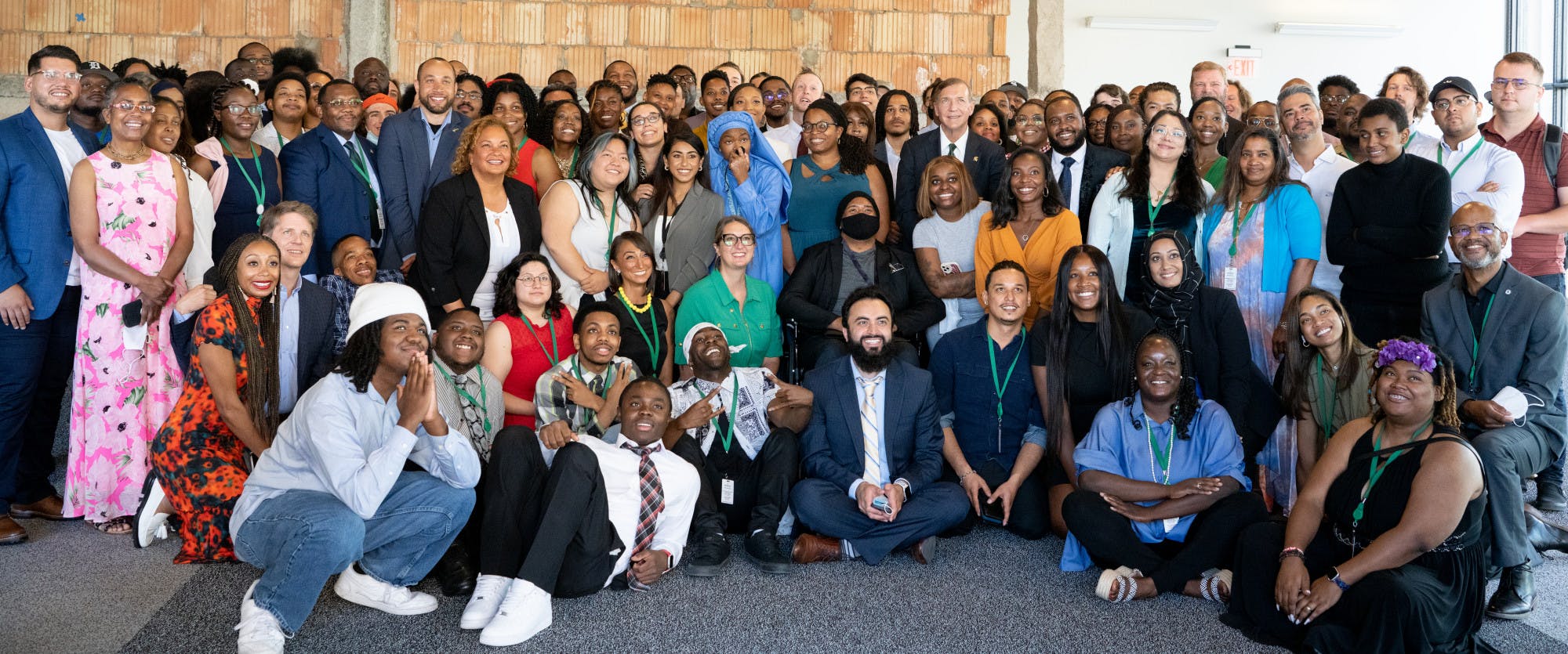 The first class of graduates from the Apple Developer Academy pose for a portrait alongside MSU's President Stanley, Apple's Vice President Lisa Jackson and Gibert Family Foundation Executive Director Laura Grannemann in Detroit on June 30, 2022.