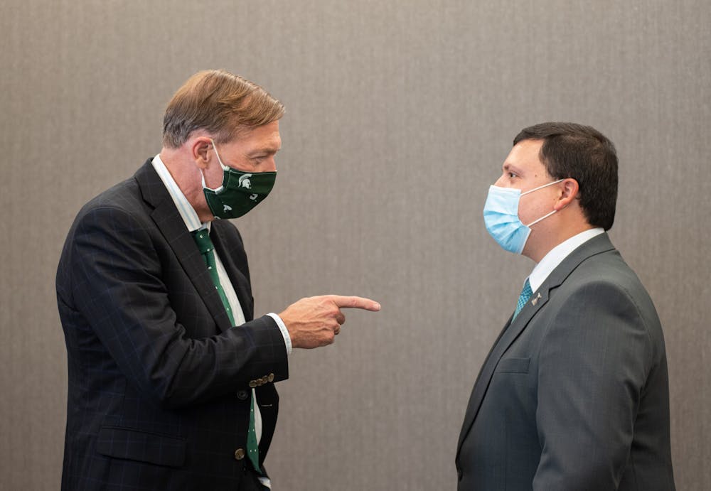 Michigan State's President Stanley shares a word with Xavier DeGroat, founder of the Xavier DeGroat Autism Awareness Foundation photographed on Sept. 29, 2021.