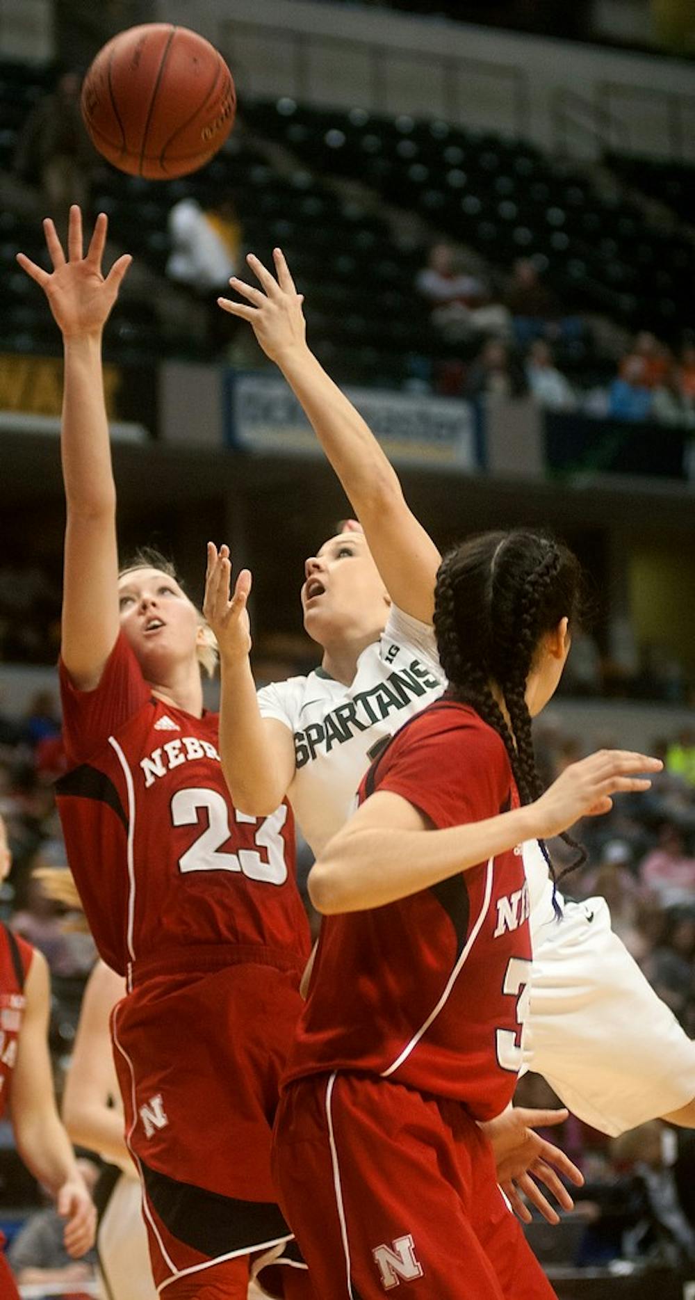 <p>Freshman guard Tori Jankoska shoots the ball while defended by Nebraska forward Emily Cady on March 8, 2014, at Bankers Life Fieldhouse in Indianapolis. The Spartans were defeated, 86-58, and will not advance to the Big 10 Championship. Betsy Agosta/The State News</p>