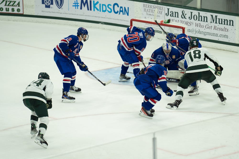 <p>Graduate student Miroslav Mucha (18) attempts to score at Munn Ice Arena on Oct. 1, 2022. The Spartans lost to the USNTDP 4-3.</p>