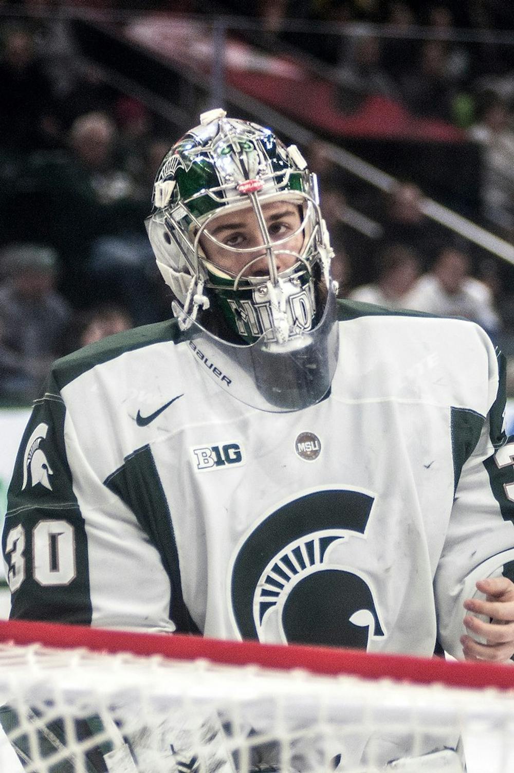 <p>Junior goaltender Jake Hildebrand skates around the goal Feb. 13, 2015, at Munn Ice Arena. The Spartans defeated Penn State, 3-0. The teams will play each other again Feb. 14, 2015. Allyson Telgenhof/The State News.</p>