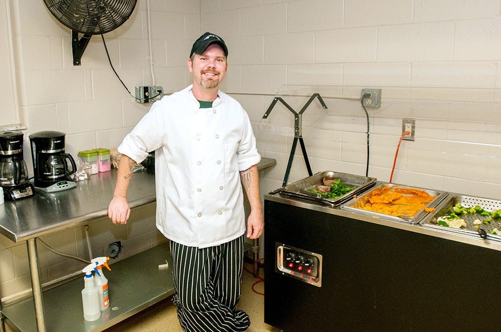 	<p>Chef Jason Hoffman poses in front of the buffet he puts on for the Alpha Epsilon Pi fraternity, 225 N. Harrison Road, on Tuesday, Oct. 2, 2012. Hoffman is an employee of Campus Cooks which provides food services to more than 19 college campuses across the country. James Ristau/The State News</p>