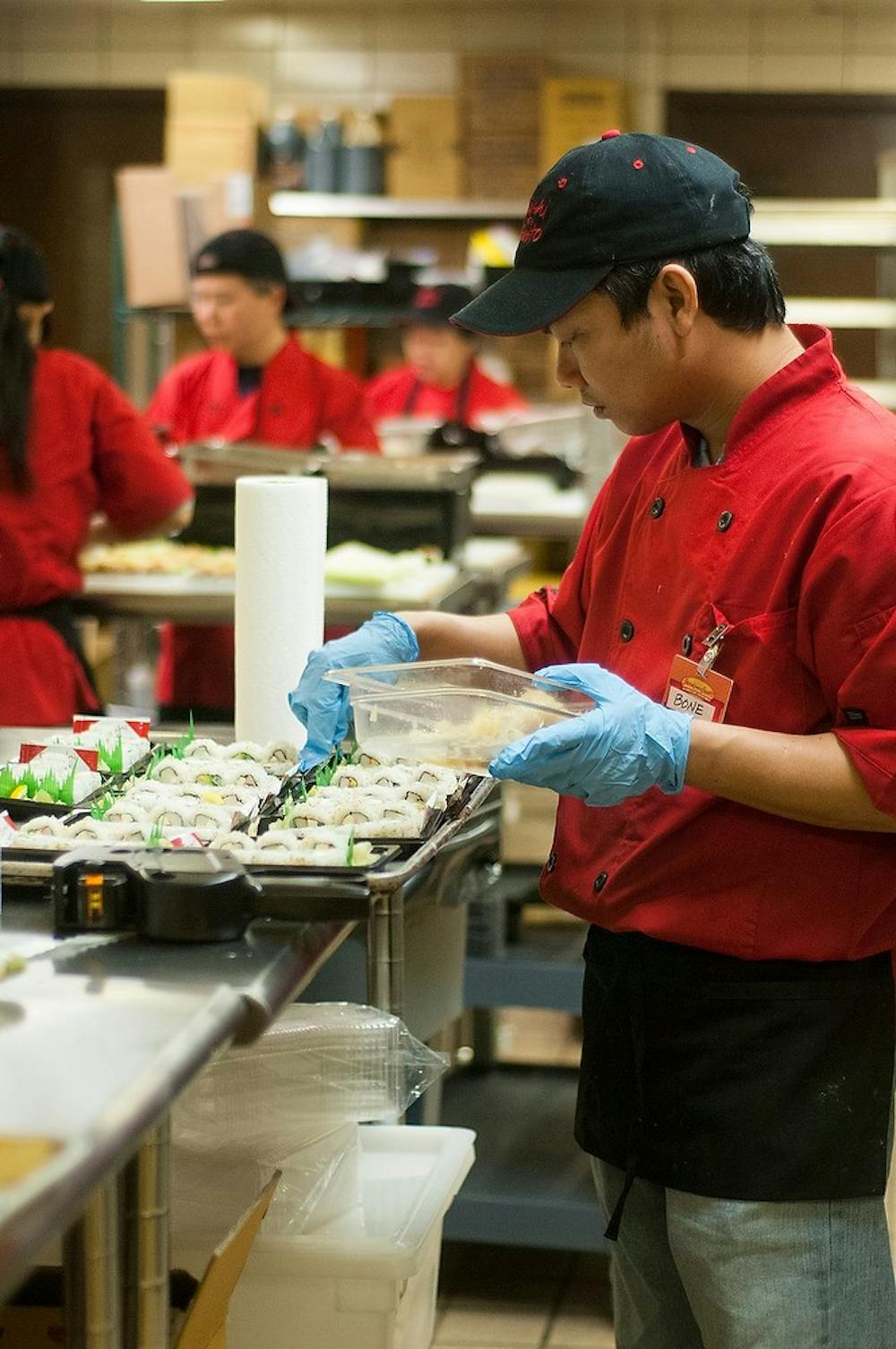 <p>Okemos resident Bone Soe packages sushi March 26, 2015, in the kitchen at McDonel Hall on East Shaw Lane. The Sushi with Gusto employees work from 12 a.m. to 7 a.m. to provide sushi for students. Hannah Levy/The State News</p>