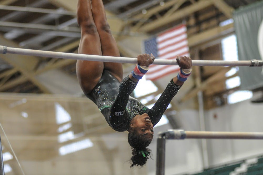 <p>Roya Shirley on the bars at the women’s gymnastics meet at Jenison Field House March 17, 2019. The Spartans placed first against Alaska, Ball State and UIC.</p>