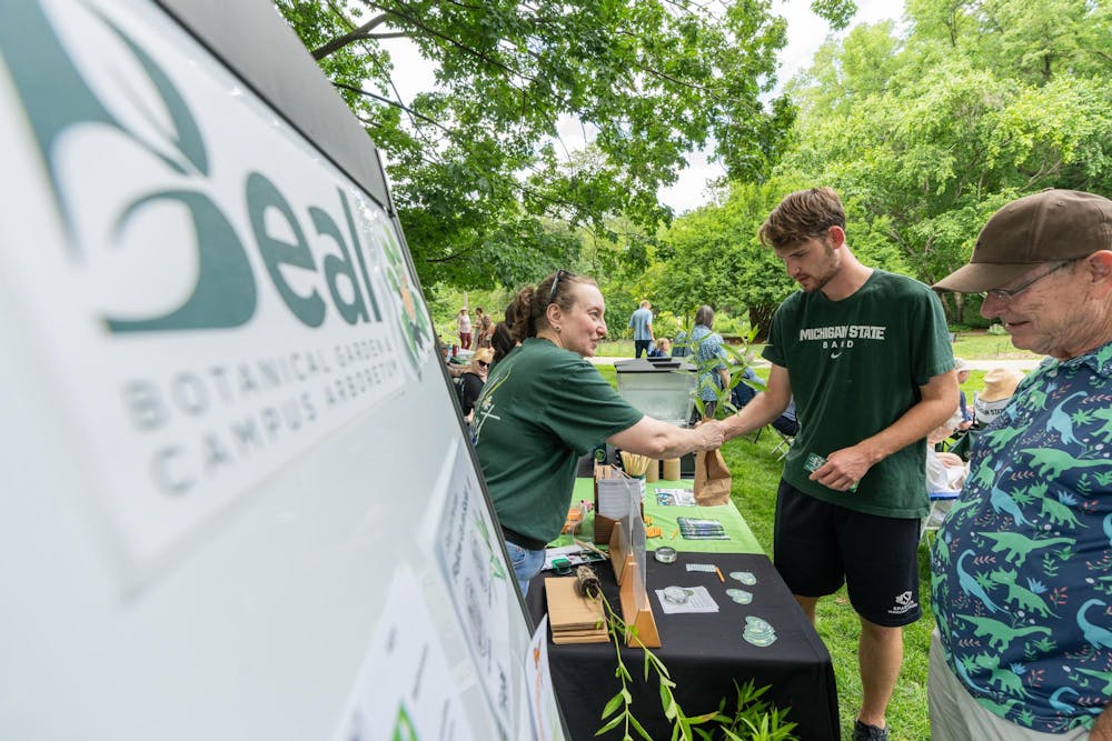 <p>Attendees of the Music and the Garden event are offered milkweed plants by Beal Botanical Garden volunteers in East Lansing, Mich., on June 28, 2026.</p>