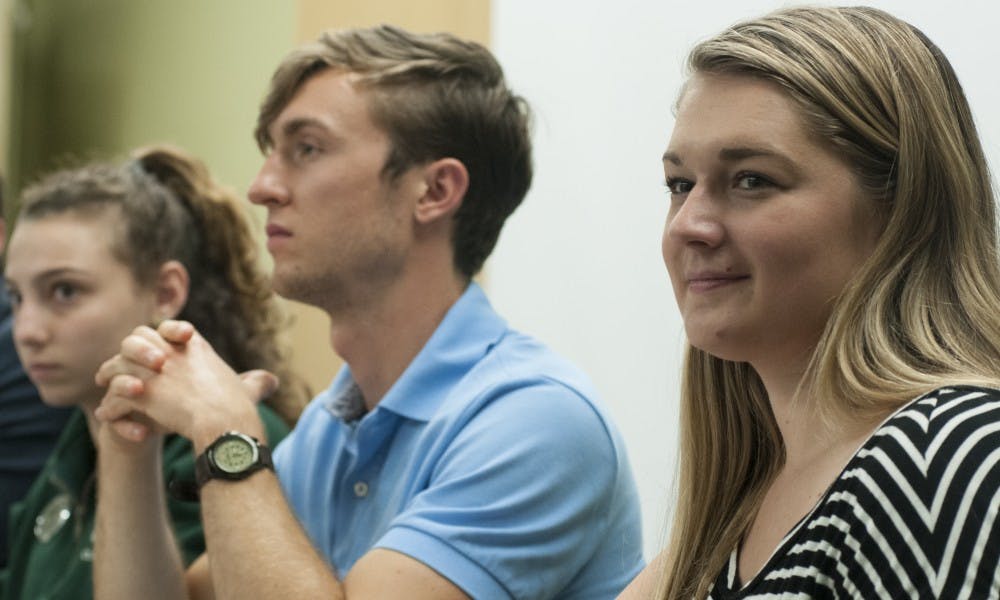 <p>From left to right, Vice President for Internal Administration Katherine Rifiotis, Vice President for Government Affairs Tyler VanHuyse and Chief of Staff Lauren Fish during an ASMSU meeting on Aug. 27, 2017 at Student Services.</p>