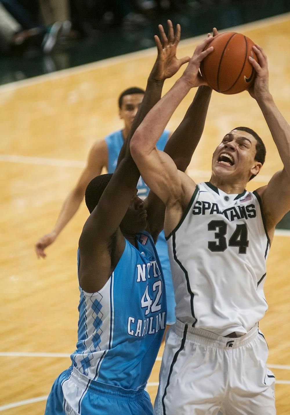 	<p>Freshman forward Gavin Schilling goes up for a shot while defended by North Carolina forward Joel James on Dec. 4, 2013, at Breslin Center. The Spartans lost to the Tar Heels, 79-65. Danyelle Morrow/The State News</p>