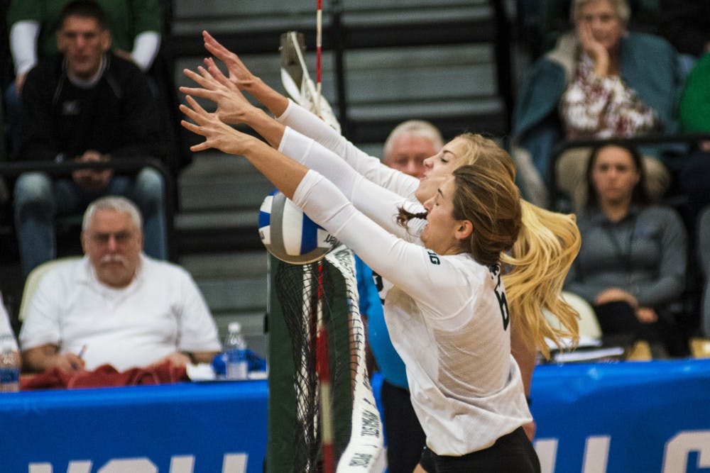 Senior middle blocker Allyssah Fitterer (6) and junior setter Rachel Minarick (12) block a spike during the first round of the NCAA Championship against Fairfield University on Dec. 2, 2016 at Jenison Field House. The Spartans defeated the Stags, 3-0.