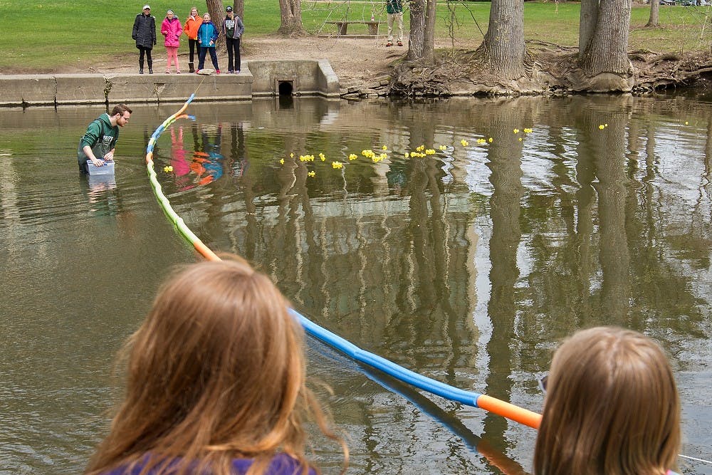 <p>Premedical and marketing junior Tristan Worthington watches the neck-and-neck conclusion to the Duck Race April 25, 2015, in the Red Cedar River by Wells Halls. Simon Schuster/The State News</p>