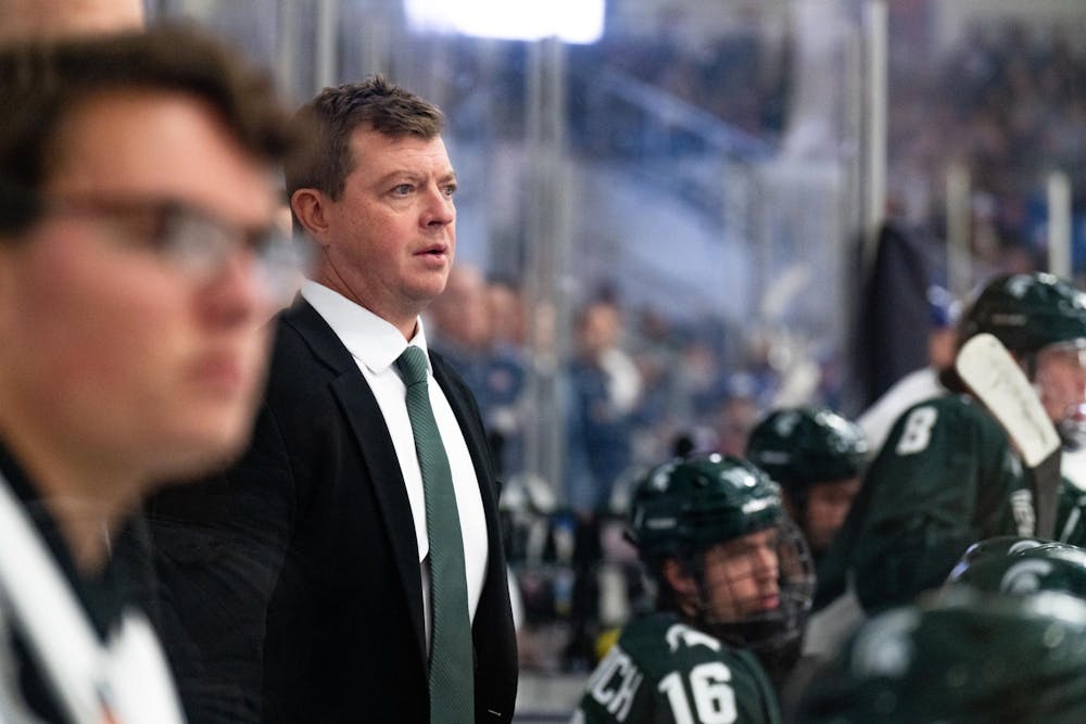 <p>Michigan State men's hockey head coach Adam Nightingale watches his team play against the under-18 U.S. Men's National Team Development Program at USA Hockey Arena in Plymouth, Michigan on Nov. 21, 2024. In front of a sold out crowd, the Spartans captured a convincing 6-2 victory, showcasing why they deserve their ranking of number two in the nation.</p>