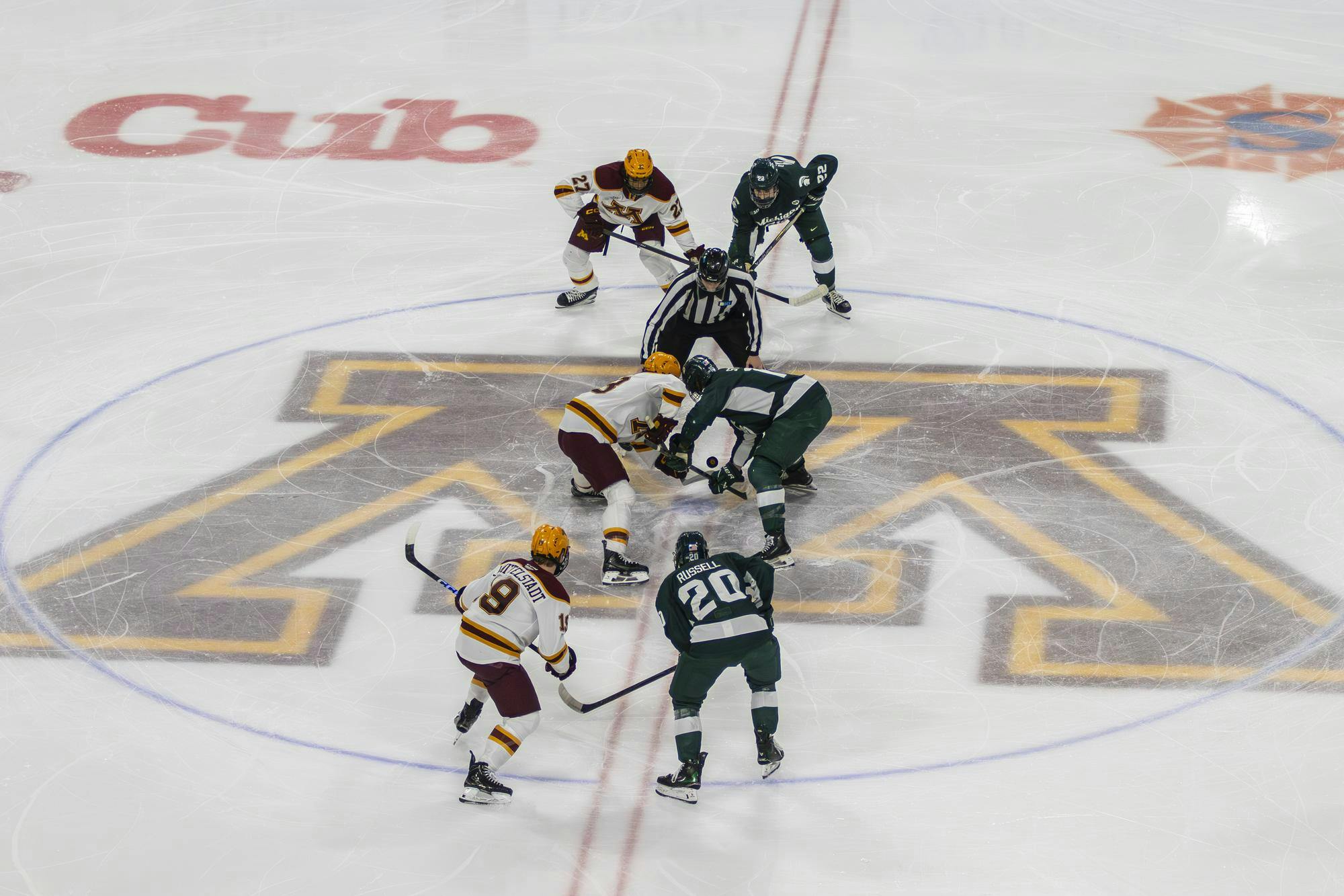 Minnesota forward Jimmy Clark (23) and Michigan State senior forward Charlie Stramel (15) faceoff to open a game between Michigan State and the University of Minnesota at 3M Arena at Mariucci in Minneapolis, Minnesota, on Friday, March 6, 2026.