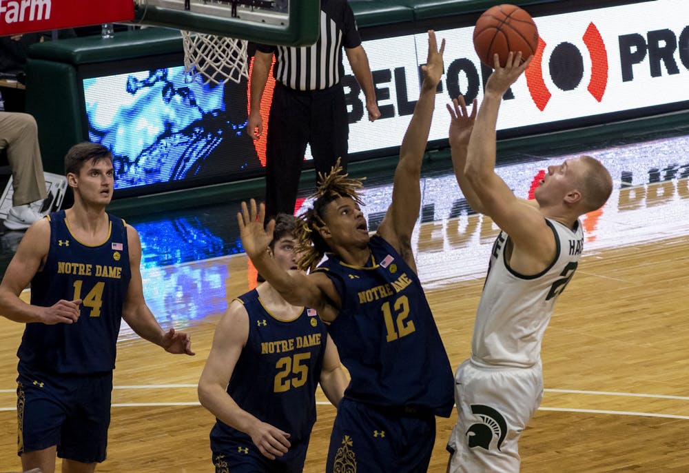 Redshirt-junior forward Joey Hauser (20), the new recruit from Marquette, shoots and scores in the second half in their game against the Fighting Irish. Michigan State triumphed over Notre Dame, 80-70, on Nov. 28, 2020. 