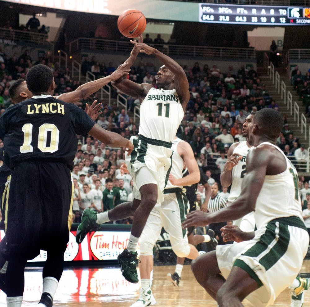 <p>Sophomore guard Lourawls 'Tum Tum' Nairn Jr., attempts a basket over Arkansas-Pine Bluff guard Jaquan Lynch, 10, during the second half of the game against Arkansas-Pine Bluff on Nov. 20, 2015 at Breslin Center. The Spartans defeated the Golden Lions, 92-46.</p>