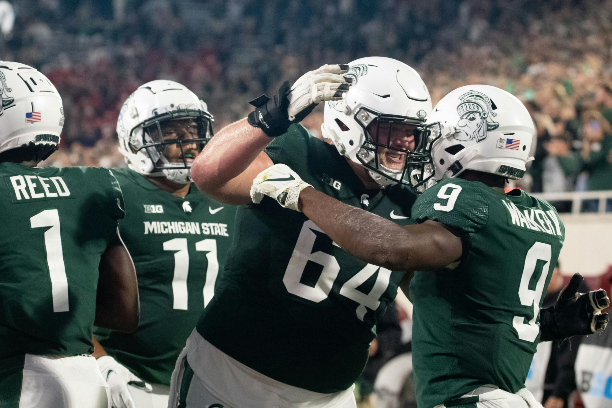 <p>Spartans share a quick celebration after junior running back Kenneth Walker lll (9) makes a touchdown during the homecoming game against Western Kentucky on Oct. 2, 2021. </p>