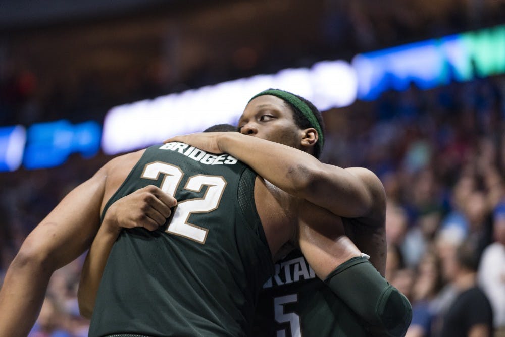 Freshman forward Miles Bridges (22) and freshman guard Cassius Winston (5) embrace during the second half of the game against University of Kansas in the second round of the Men's NCAA Tournament on March 19, 2017 at  at the BOK Center in Tulsa, Okla.The Spartans were defeated by the Jayhawks, 90-70.