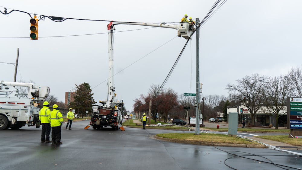 <p>Ingham County Road Department, Lansing Board of Water and Light and Xfinity work to repair lines down on Hagadorn. The fallen lines caused power outages east of MSU campus. Dec. 11, 2021. </p><p><br/></p><p><br/></p>