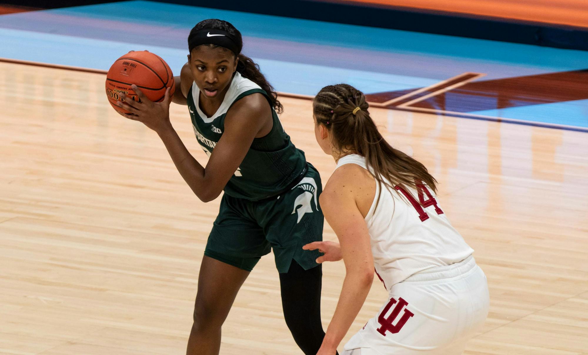 <p>Then-junior guard Nia Clouden (24) stares down an Indiana player during the first quarter of the game. The Spartans advanced to the semifinals of the Big Ten Tournament after defeating the Hoosiers, 69-61, at Bankers Life Fieldhouse. Shot on March 11, 2021.</p>