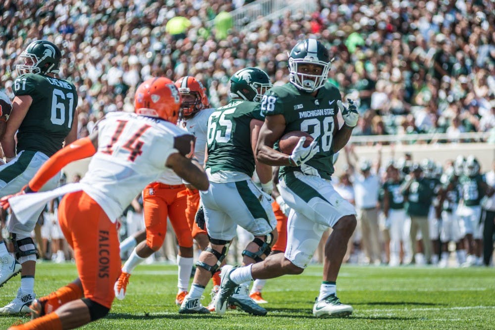 <p>Junior running back Madre London (28) carries the ball into the end zone for a touchdown during the game against Bowling Green on Sep. 2, 2017, at Spartan Stadium. The Spartans defeated the Falcons, 35-10.&nbsp;</p>