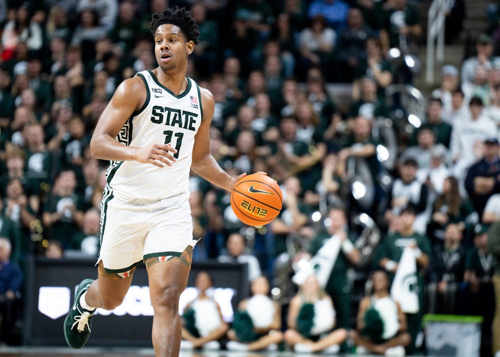 Junior guard AJ Hoggard (11) dribbles down the court during a game against Purdue University at Breslin Center on Jan. 16, 2023. The Spartans fell to the Boilermakers with a score of 64-63. 
