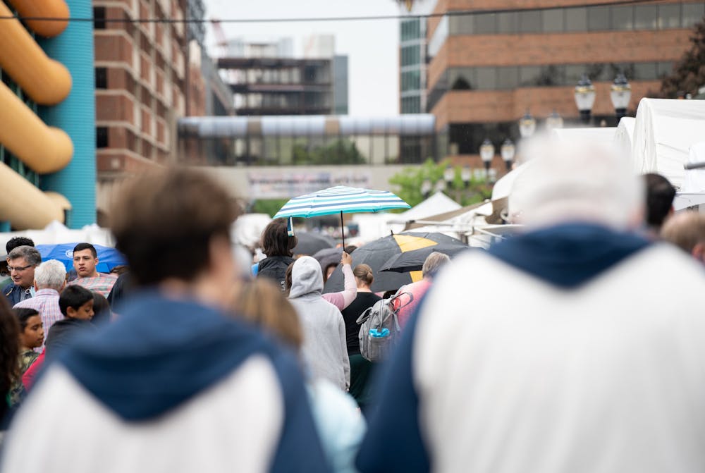 <p>An umbrella comes out at the East Lansing Art Festival on May 21, 2022. The festival ran through rain and shine in downtown East Lansing over the weekend.</p>