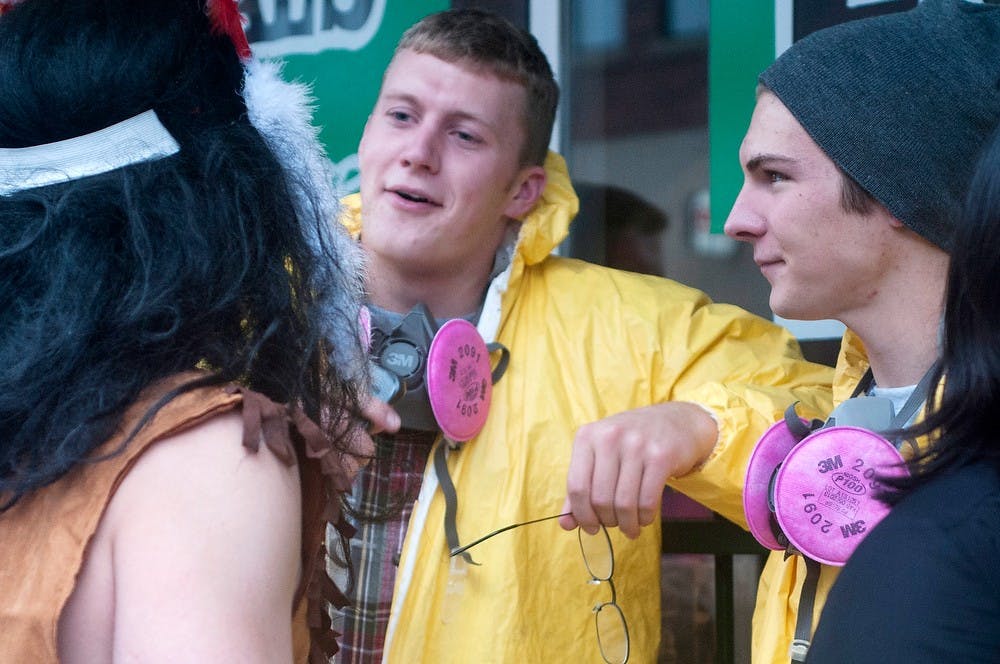 	<p>Romeo, Mich., resident Bill Blancke, left, fisheries and wildlife senior Chris Dohrmann, center, and zoology senior Matt Hiles, right, wait in line Oct. 31, 2013, outside of The Riviera Cafe Restaurant, 321 M.A.C. Dozens of students and visitors went to the bar dressed in Halloween costumes and ready to purchase $3 pitchers. Margaux Forster/The State News</p>