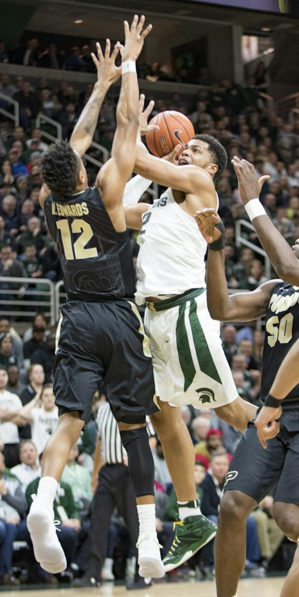 Freshman guard and forward Miles Bridges (22) attempts to dunk the ball as he is defended by Purdue forward Vincent Edwards (12) during the first half of the men's basketball game against Purdue on Jan. 24, 2017 at Breslin Center. The Spartans were defeated by the Boilermakers, 84-73.