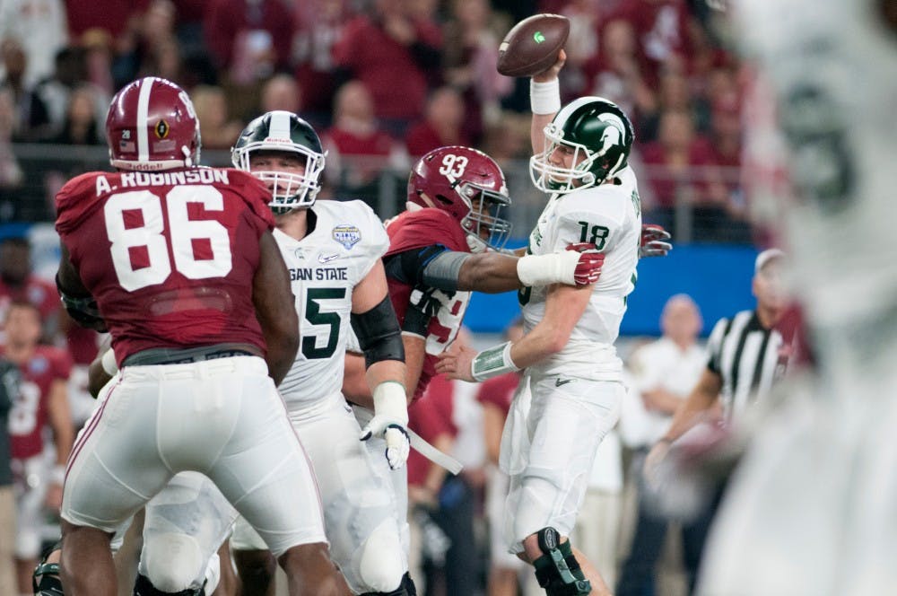 Alabama defensive lineman Jonathan Allen sacks senior quarterback Connor Cook in the first quarter during the Goodyear Cotton Bowl Classic on Dec. 31, 2015 at AT&T Stadium in Arlington, Texas. Alabama leads at the half, 10-0.