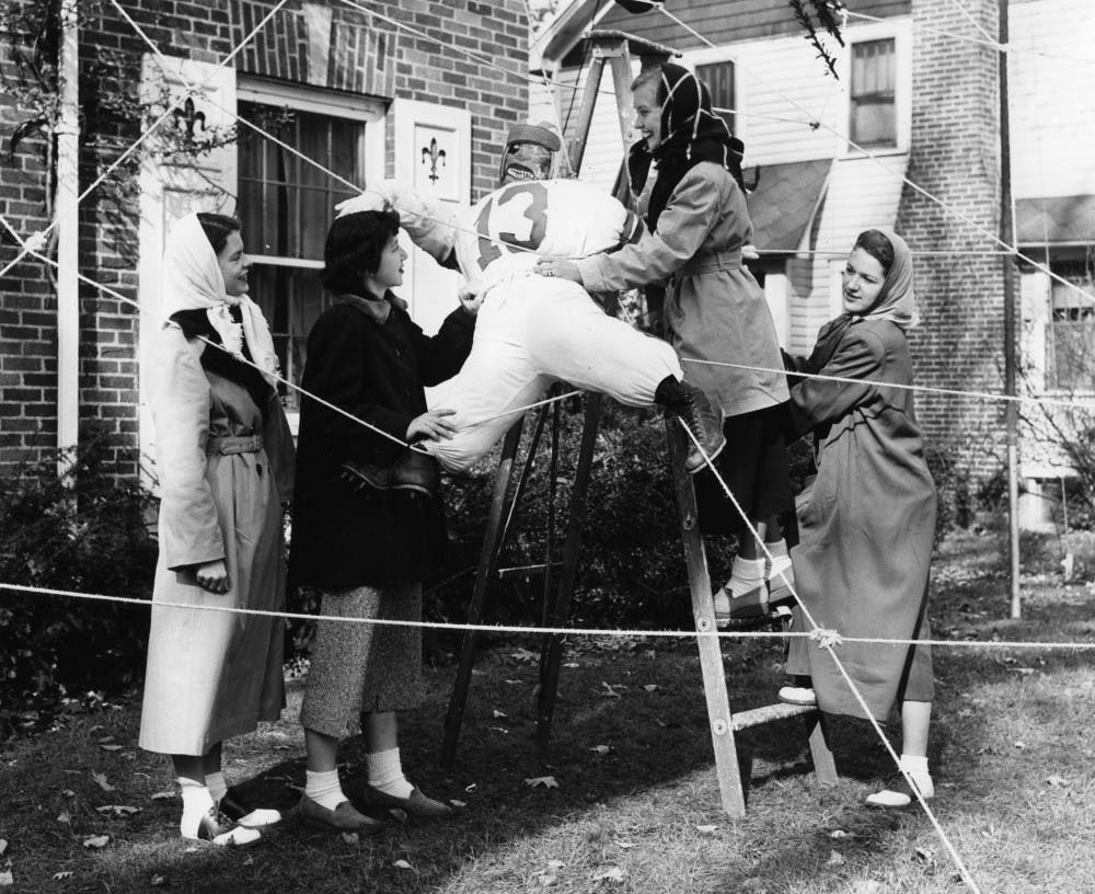 <p>A stuffed football player is staged as a homecoming decoration by four women in East Lansing 1949. The Spartan football team would finish with a 6-3 record and ranked 19 in the final AP Poll for the 1949 season. The team was led by head coach Biggie Munn, who would lead the Spartans to their first ever Rose Bowl victory in 1954, defeating the UCLA Bruins.</p>