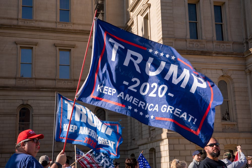 <p>A Trump 2020 flag at the Stop The Steal rally at the Michigan State Capital on Saturday, November 7, 2020. </p>